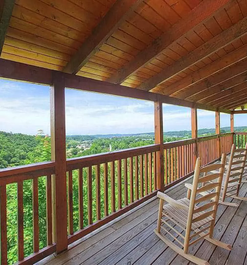 rocking chairs on cabin porch facing mountain view