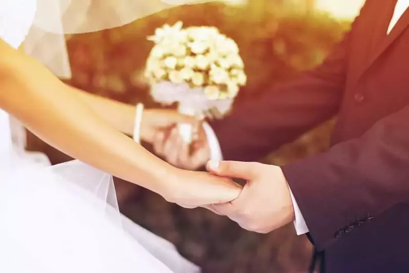 Bride and groom holding hands