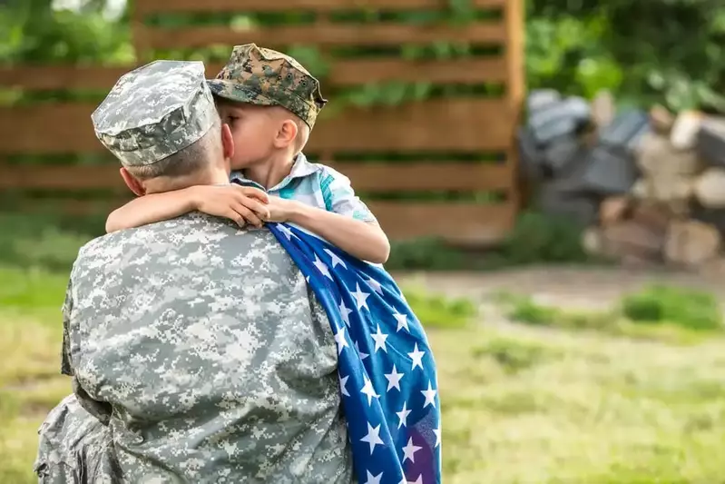 Military father hugging son