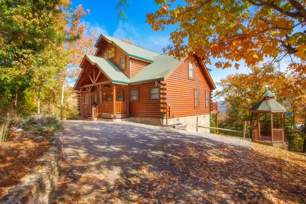 Morning Star cabin surrounded by fall foliage with mountain view behind the cabin