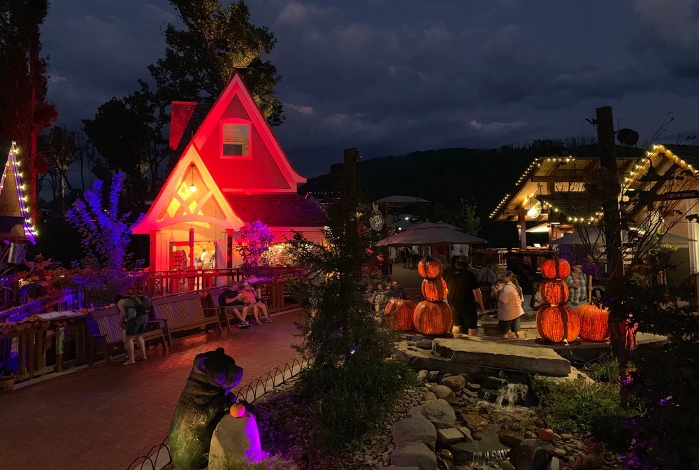 Anakeesta's Firefly Village decorated for fall with lights and pumpkins at night