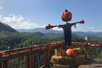 pumpkin scarecrow and fall decor in front of mountain view at Anakeesta