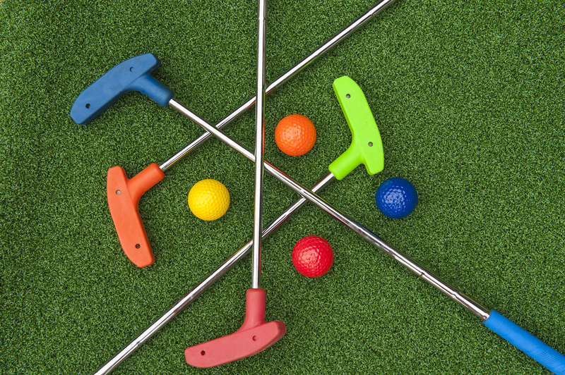 mini-golf putters and golf balls of various colors