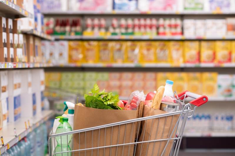 grocery cart filled with bags of groceries