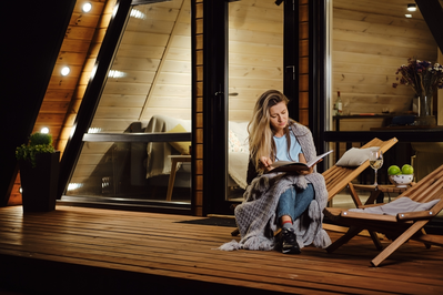 woman reading at cabin