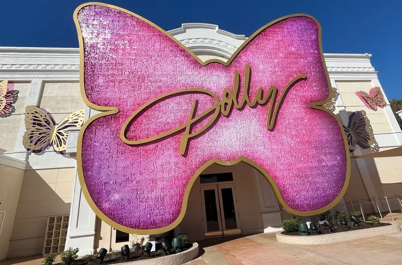 pink butterfly-shaped Dolly sign at the Dolly Parton Experience in Dollywood