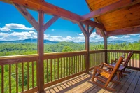 two chairs on the deck of a romantic Gatlinburg cabin with mountain views